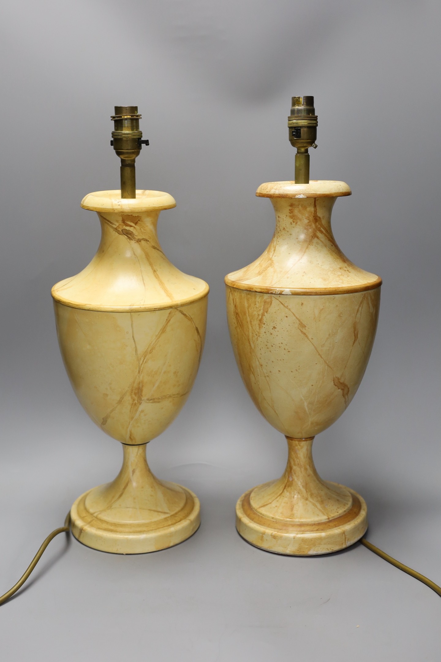A pair of faux marble toleware style lamps, 41 cms high not including fittings